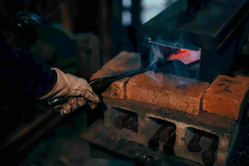 Steel in forge with smoke