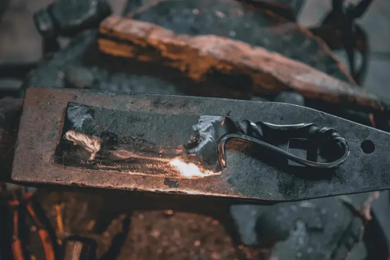 Woman hammering glowing blade